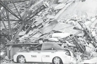  ?? REUTERS/Ginnette Riquelme ?? A damaged taxi is seen next to a collapsed building after an earthquake in Mexico City, Mexico September 19, 2017.