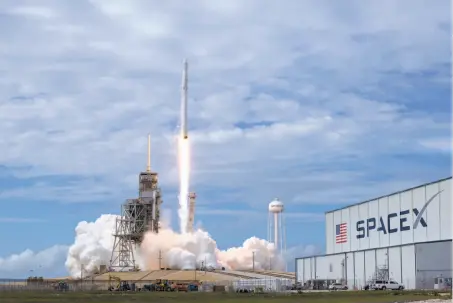  ?? Bill Ingalls / NASA ?? The SpaceX Falcon 9 rocket, with the Dragon spacecraft on board, launches from NASA’s Kennedy Space Center in June.