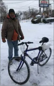  ?? RICHARD PAYERCHIN — THE MORNING JOURNAL ?? Allen Quinn, 60, of Lorain, stands with his bicycle that he rode to The Stop Convenient Store on East Erie Avenue in Lorain on Jan. 20, 2019. His advice for cold weather riding: Wear at least two of everything.