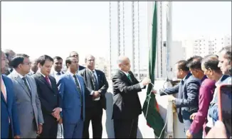  ?? ?? Ambassador Md Ashikuzzam­an hoisting the National Flag.