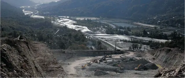  ?? DMITRY LOVETSKY/ THE ASSOCIATED PRESS ?? Excavators move earth at a quarry near Akhshtyr Village in Sochi. As a centrepiec­e of its Olympic bid, Russia trumpeted a ‘ zero waste’ program that really hasn’t panned out.