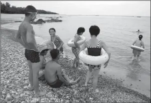  ?? The Associated Press ?? SEASHORE: North Koreans enjoy the day on a seashore on Aug. 20 near Mount Chilbo, North Korea.