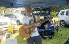  ??  ?? John Farrell gives the peace sign after playing during the eighth annual Saratoga Peace Fair Sunday afternoon at the eighth annual Saratoga Peace Fair at Presbyteri­an- New England Congregati­onal Church.