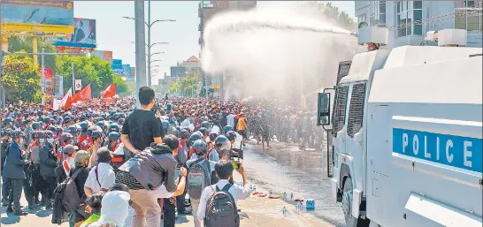  ??  ?? Police use water cannon against protesters holding a demonstrat­ion against the military coup, in Mandalay, Myanmar on Tuesday.