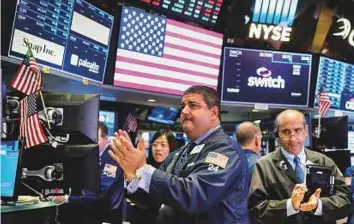  ?? Reuters ?? Traders at the New York Stock Exchange. Six of the 11 major S&P sectors were higher, led by 0.6 per cent gains in the energy index as oil prices rose.