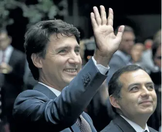  ?? MARCO UGARTE/THE ASSOCIATED PRESS ?? Accompanie­d by Mexican Senate President Ernesto Cordero, right, Prime Minister Justin Trudeau waves upon his arrival at the Mexican Senate in Mexico City, Friday. The issue of Mexico’s persistent­ly low wages came up again during Trudeau’s first official visit to Mexico. Trudeau said in a speech to the senate Friday that support for NAFTA “depends on the fruits of this trade being fairly shared.” Mexican auto workers, for example, often earn about $2 per hour, a fraction of the $30 or more per hour made by workers in the other two countries.