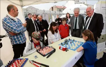  ?? (Photo Laurent Martinat) ?? Sous les yeux du maire Jean-Pierre Giran et de Bachar Kouatly, président de la Fédération française d’échecs, une partie oppose Léa et Théo, ce dernier étant non-voyant.