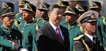  ?? AP PHOTO/THEMBA HADEBE ?? Chinese President Xi Jinping (center) inspects the honour guard during an official welcoming ceremony at the government’s Union Buildings in Pretoria, South Africa, on Tuesday.