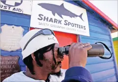  ?? Picture: AP ?? SIGHTED: Shark Spotter Patrick Davids on the lookout for sharks in the Muizenberg area. The new app will be fed real-time informatio­n.