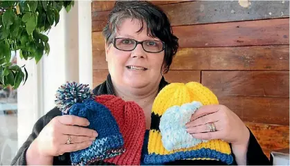  ?? EMMA JAMES ?? Brandy Smith of Cambridge is knitting free beanies for children feeling chilly this winter.