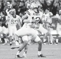  ?? RAINIER EHRHARDT/ASSOCIATED PRESS ?? Pittsburgh kicker Chris Blewitt jumps for joy with teammate Ryan Winslow after kicking the game-winning field goal to upset No. 2 Clemson on the road.