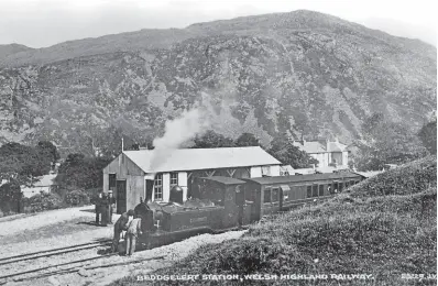  ?? VALENTINE POSTCARD/WHRHG ARCHIVE ?? Locomotive inspection: With 2569ft high Moel Hebog dominating the background, the crew of Moel Tryfan inspects the front end of the 0-6-4T at Beddgelert station shortly before the formal opening of the WHR in June 1923.