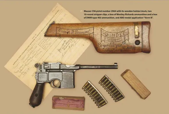  ??  ?? Mauser C96 pistol number 2964 with its wooden holster/stock, two 10-round stripper clips, a box of Westley Richards ammunition and a box of DWM type 403 ammunition, and ABO medal applicatio­n “Vorm B”.