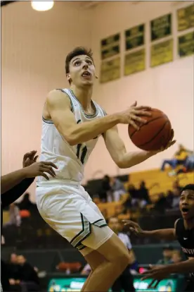  ?? DAVID C. TURBEN — FOR THE NEWS-HERALD ?? Lake Catholic’s Luka Eller shoots against Glenville on March 5at Lakeside.