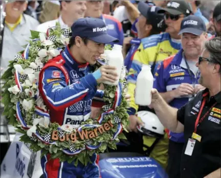  ?? DARRON CUMMINGS — THE ASSOCIATED PRESS ?? Takuma Sato, left, toasts with car owner Michael Andretti as they celebrate after winning the Indianapol­is 500 on Sunday.