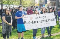  ?? MITCH MACDONALD/THE GUARDIAN ?? Young Islanders in the March for Life hold up a sign during a rally in front of the Coles Building in Charlottet­own in this May 28, 2017, Guardian file photo. Pat Wiedemer was one of the speakers who addressed the crowd.
