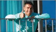  ?? (AFP) ?? This handout picture released by the Portuguese Football Federation shows Cristiano Ronaldo giving the thumb up as he watches his teammates’ training session from a balcony at Portugal’s training camp in Oeiras, on the outskirts of Lisbon, on Tuesday.