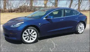  ?? ROBERT DUFFER/CHICAGO TRIBUNE ?? Tesla Model 3 in deep blue metallic paint with 19-inch wheels pictured in Arlington Heights, Ill., on April 7.