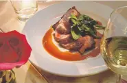  ?? Cyrus McCrimmon, Denver Post file ?? Crispy duck breast, with persimmon-herb bread pudding and spicy pepper jelly glaze, at Tables, in March 2015.