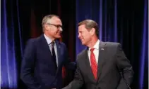  ?? ASSOCIATED PRESS FILE PHOTO ?? Republican candidates for Georgia governor Lt. Gov. Casey Cagle, left, and Secretary of State Brian Kemp shake hands July 12 after an Atlanta Press Club debate at Georgia Public Television in Atlanta.