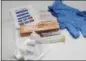  ?? ASSOCIATED PRESS FILE ?? The contents of a drug overdose rescue kit at a training session on how to administer naloxone, which reverses the effects of heroin and prescripti­on painkiller­s