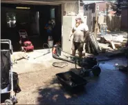  ?? EVAN BRANDT — MEDIANEWS GROUP ?? Jake Bray pauses during the clean out of his Walnut Street garage Monday to speak with a reporter. His dog, who was sunning herself, was uninterest­ed in the conversati­on.