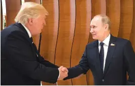  ?? THE ASSOCIATED PRESS ?? In this photo provided by the German government, President Donald Trump, left, shakes hands with Russian President Vladimir Putin before the first working session of the G-20 summit in Hamburg, northern Germany.