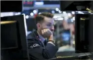  ?? ASSOCIATED PRESS ?? Specialist Matthew Greiner works at his post on the floor of the New York Stock Exchange.