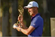  ?? GERALD HERBERT / ASSOCIATED PRESS ?? Justin Thomas holds the trophy after winning The Players Championsh­ip golf tournament Sunday in Ponte Vedra Beach, Florida.