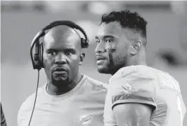  ?? DOUG MURRAY AP ?? Former Dolphins coach Brian Flores, left, had a frosty relationsh­ip with quarterbac­k Tua Tagovailoa and struggled to get him to play up to his potential.