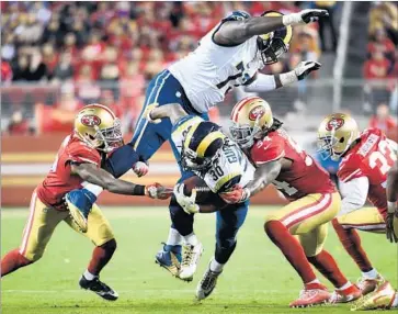  ?? Wally Skalij Los Angeles Times ?? OFFENSIVE LINEMAN Greg Robinson goes over the top as Rams running back Todd Gurley is brought down by the San Francisco 49ers in the opening game of the regular season Sept. 12 in Santa Clara.