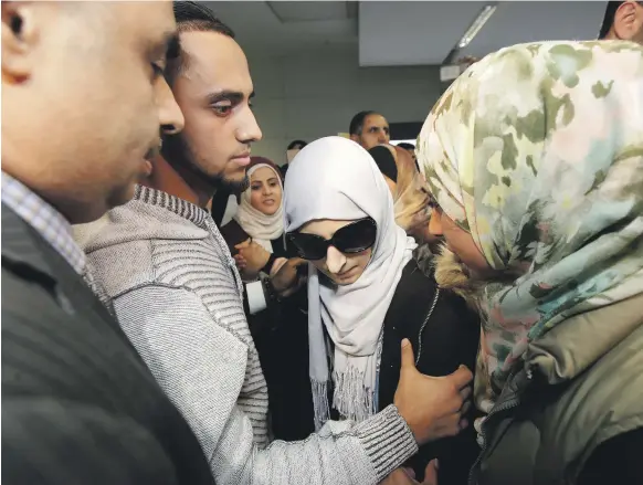  ?? AP ?? Shaima Swileh and her husband Ali Hassan at San Francisco Internatio­nal Airport on Wednesday night after she won her fight for a travel ban waiver