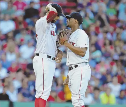  ?? STAFF PHOTO BY JOHN WILCOX ?? HOT TOPIC OF CONVERSATI­ON: Red Sox starter David Price gets a visit on the mound from shortstop Xander Bogaerts during last night’s 7-2 loss to the Texas Rangers at Fenway Park.