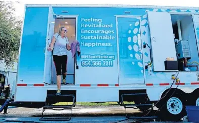  ?? SUSAN STOCKER/STAFF PHOTOGRAPH­ER ?? Peggy O'Neal steps out of the Live Fresh-Hope South Florida mobile shower at St. Christophe­r Episcopal Church in Fort Lauderdale.