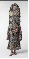  ?? (Courtesy of Crystal Bridges Museum) ?? Fabric with appliquéd crochet and buttons, knitted yarn, and metal armature makes up Nick Cave’s “Soundsuit” (2009).