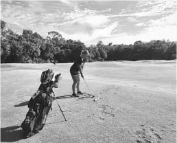  ?? ORLANDO SENTINEL ?? Freshman Zoe Allaux makes her final adjustment­s before swinging during practice Oct. 22 at the Twin Rivers Golf Club.