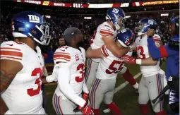  ?? ALEX BRANDON ?? New York Giants outside linebacker David Mayo (55) lifts tight end Kaden Smith, center, after he caught the game-winning touchdown pass from quarterbac­k Daniel Jones during overtime of an NFL football game against the Washington Redskins.