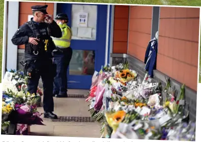  ??  ?? Tributes: Bouquets left outside Croydon police station yesterday