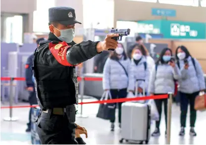  ?? Photo: VCG ?? ▴ A railway police officer participat­es in a drill at a railway station in Nanjing, East China’s Jiangsu Province on January 7, 2022.