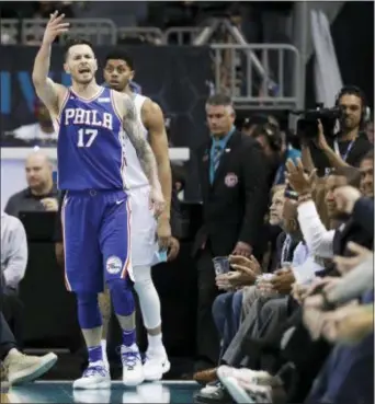  ?? CHUCK BURTON — THE ASSOCIATED PRESS ?? The 76ers’ JJ Redick (17) gestures toward a fan first quarter in Charlotte, N.C., on Tuesday. after making a basket at the end of the