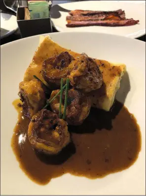  ?? Arkansas Democrat-Gazette/ERIC E. HARRISON ?? Petit & Keet’s savory brunch menu items include the Shrimp & Blintz, a “Gouda” blini topped with New Orleans-style BBQ shrimp.