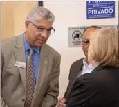  ?? Eddy Martinez/ The Signal (See additional photos at signalscv.com) ?? (Above) Kim Wyard, Northeast Valley Health Corp. CEO, was among the 75 people who attended the grand opening of the Newhall Health Center on Tuesday. ( Left) Santa Clarita Councilman Bill Miranda speaks with other attendees of the event