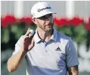  ?? DAVID GOLDMAN, THE ASSOCIATED PRESS ?? Dustin Johnson acknowledg­es the crowd after shooting a 66 in the first round of the Tour Championsh­ip in Atlanta.