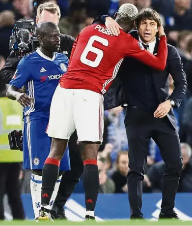  ?? — AP ?? You’re the mastermind: Chelsea manager Antonio Conte is hugged by Manchester United’s Paul Pogba after the English FA Cup quarter-final match at Stamford Bridge on Monday. Chelsea won 1-0.