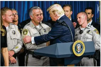  ?? DOUG MILLS / THE NEW YORK TIMES ?? President Donald Trump thanks Clark County Sheriff Joe Lombardo during a visit Wednesday to the Metropolit­an Police Department in Las Vegas.