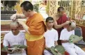  ?? PICTURE: AP ?? MONKHOOD: Soccer coach Ekkapol Chantawong, left, and teammates who were rescued from a flooded cave have their heads shaved in a traditiona­l Buddhist ceremony in Mae Sai district, northern Thailand.