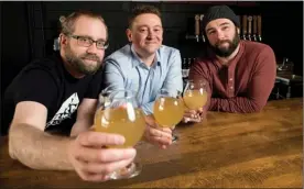  ?? The Canadian Press ?? From left, Barn Hammer Brewing Company head brewer Brian Westcott, University of Winnipeg associate professor and chair of classics Matt Gibbs, and Barn Hammer Brewing Company owner Tyler Birch pose for a photo after they teamed up to recreate an...