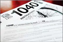  ??  ?? This file photo shows multiple forms printed from the Internal Revenue Service web page that are used for 2018 US federal tax returns in Zelienople,
Pennsylvan­ia.