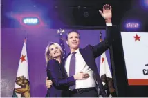  ?? Rich Pedroncell­i / Associated Press ?? Gavin Newsom hugs his wife, Jennifer Siebel Newsom, as he celebrates at his election night party in Los Angeles.