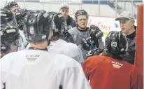  ?? JASON MALLOY • THE GUARDIAN ?? Charlottet­own Islanders listen to head coach Jim Hulton, right, at Wednesday’s practice at the Eastlink Centre.